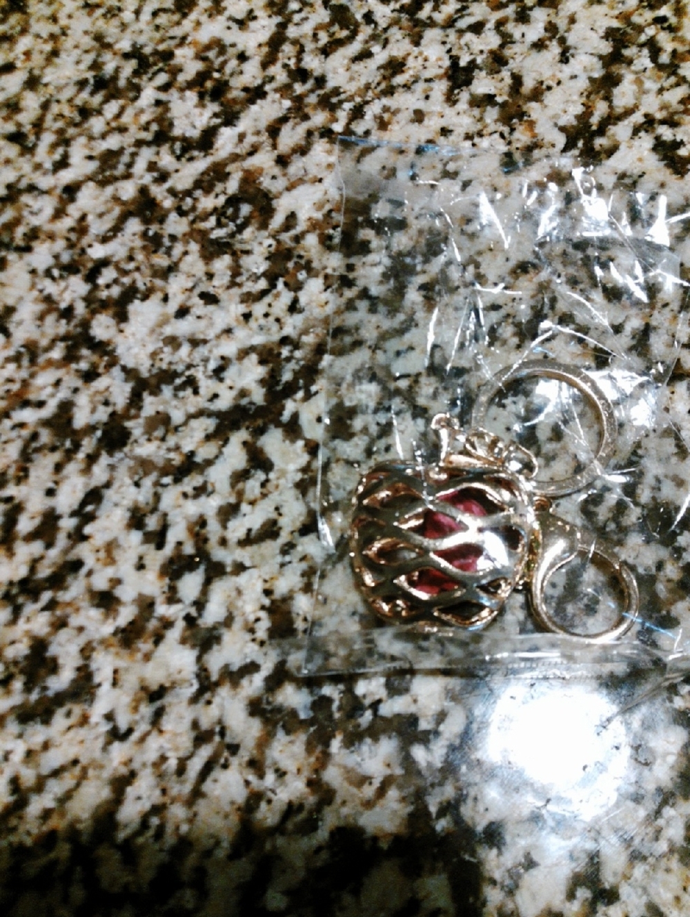 Gold Cage Locket Keyring with Red Insert